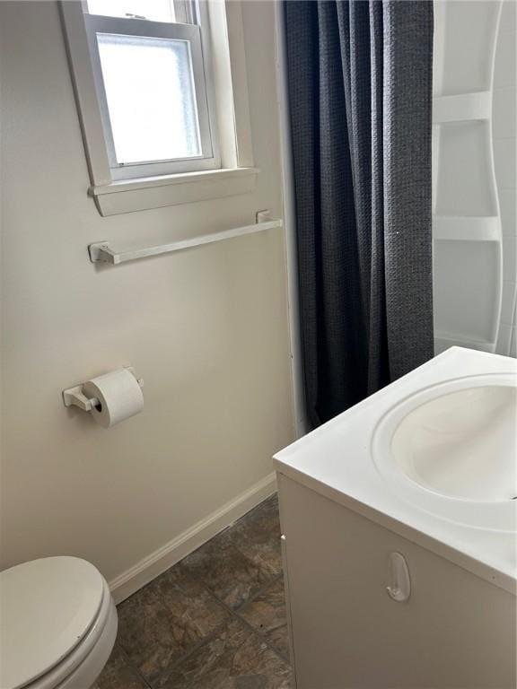 bathroom featuring toilet and vanity