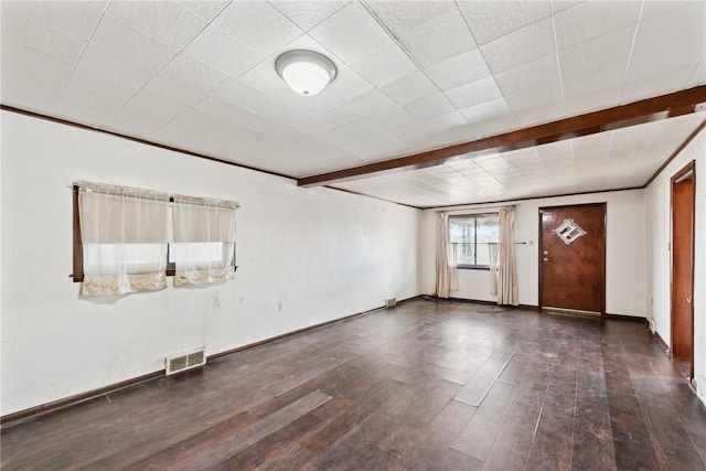 unfurnished room featuring beam ceiling and dark hardwood / wood-style floors