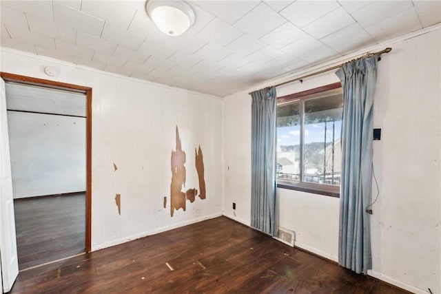 unfurnished room with dark wood-type flooring