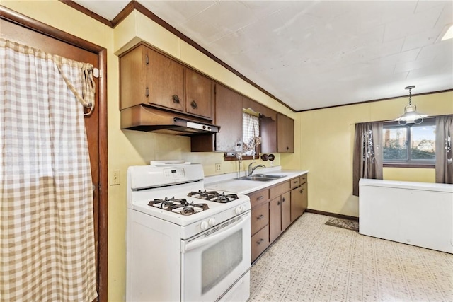 kitchen featuring sink, hanging light fixtures, ornamental molding, and white gas range oven