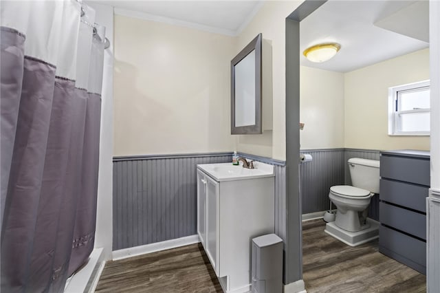 bathroom with wood-type flooring, vanity, toilet, ornamental molding, and a shower with shower curtain