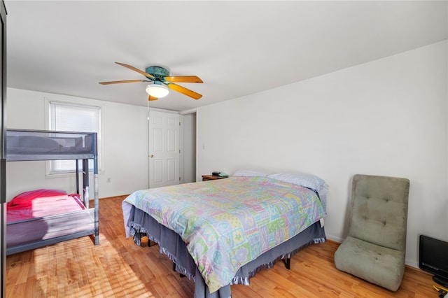 bedroom with ceiling fan and hardwood / wood-style flooring