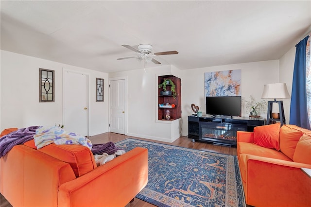 living room featuring ceiling fan and hardwood / wood-style floors