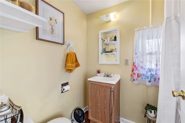 bathroom featuring toilet and vanity