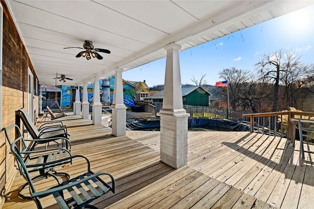 wooden terrace featuring ceiling fan