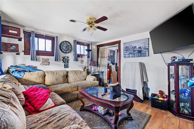 living room featuring ceiling fan and hardwood / wood-style flooring