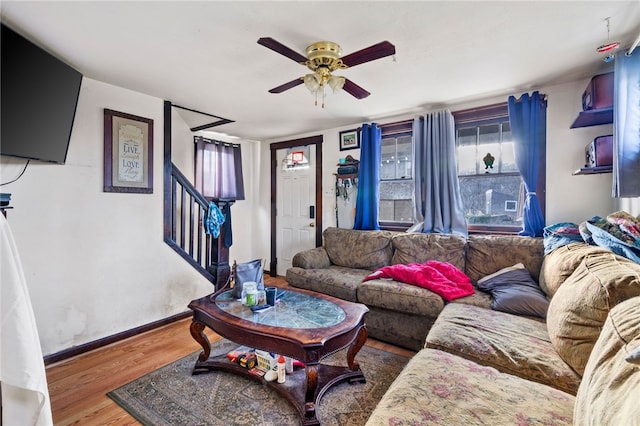 living room featuring ceiling fan and hardwood / wood-style floors