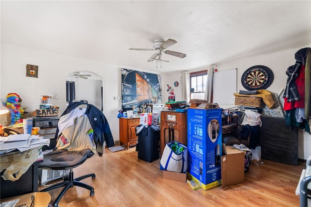 home office with ceiling fan and light hardwood / wood-style floors