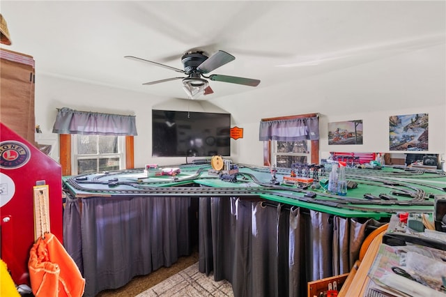 playroom featuring light carpet and ceiling fan