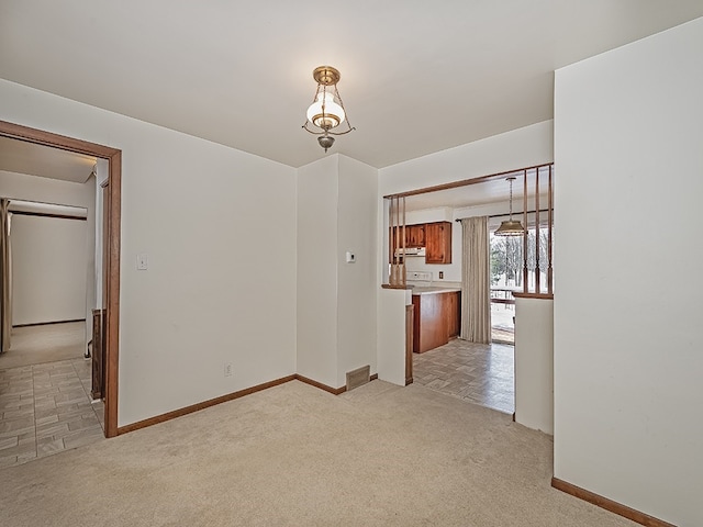 unfurnished room with light colored carpet