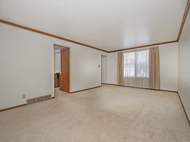 spare room featuring crown molding and light colored carpet