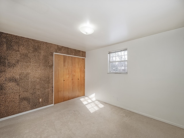 unfurnished bedroom featuring carpet and a closet