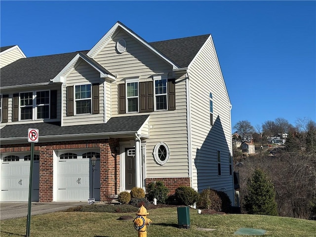 view of front facade with a garage and a front lawn