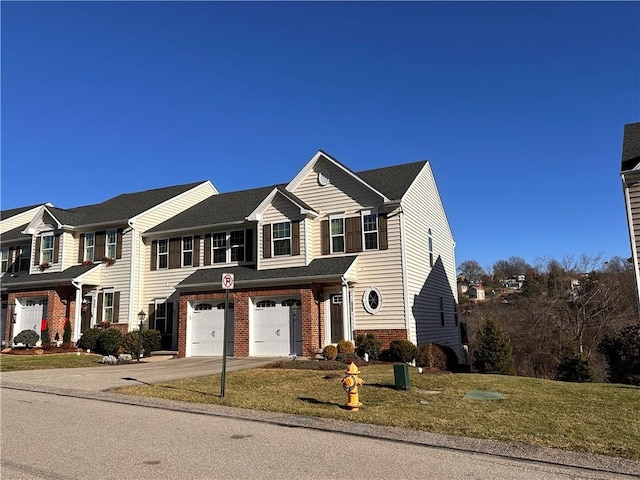 view of front of home with a front lawn and a garage