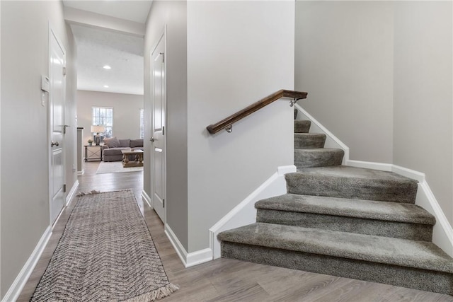 stairway featuring hardwood / wood-style floors