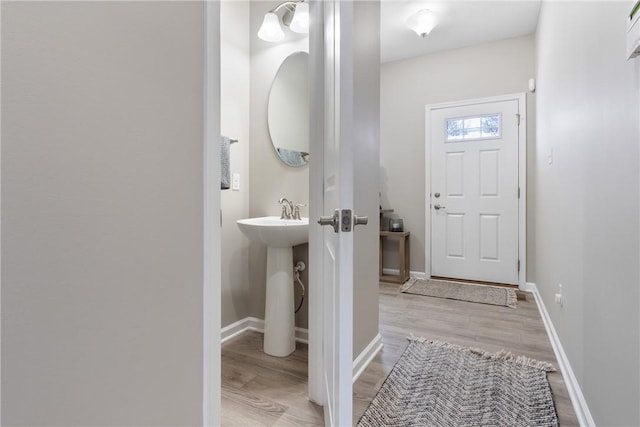 bathroom with hardwood / wood-style floors and sink