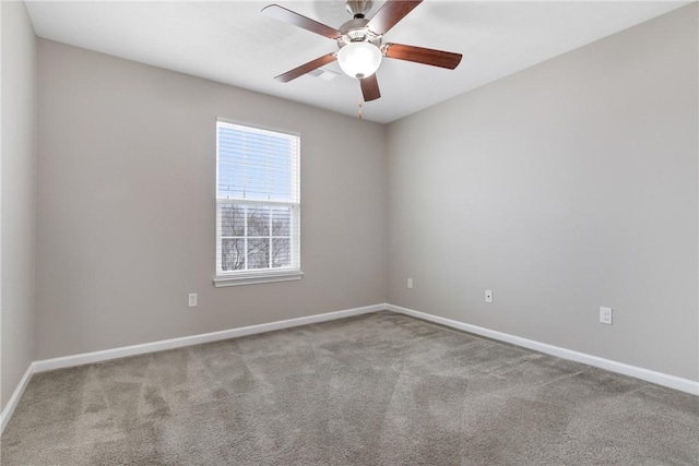 spare room with ceiling fan and light colored carpet