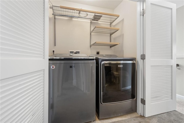 laundry area featuring light colored carpet and washer and dryer