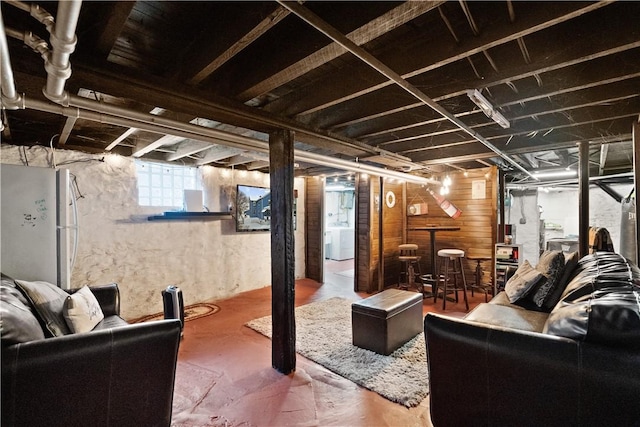 basement with washer / dryer and white refrigerator