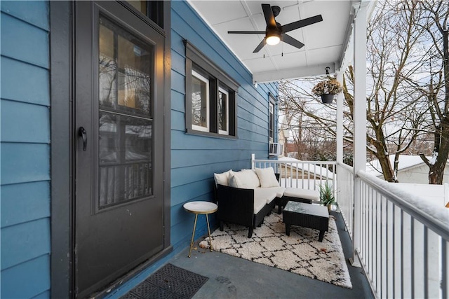 snow covered back of property featuring ceiling fan