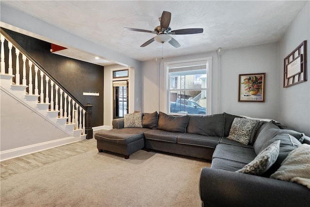 carpeted living room with ceiling fan