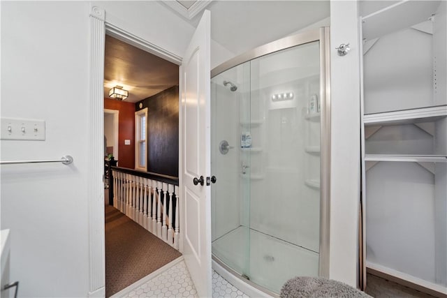 bathroom featuring walk in shower and tile patterned flooring