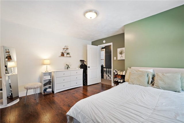 bedroom with dark hardwood / wood-style flooring