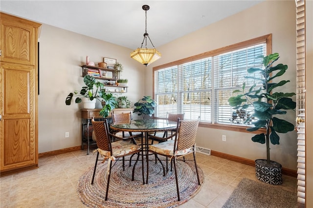 dining area featuring light tile patterned floors and a healthy amount of sunlight