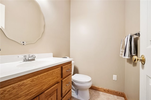 bathroom featuring toilet, vanity, and tile patterned flooring