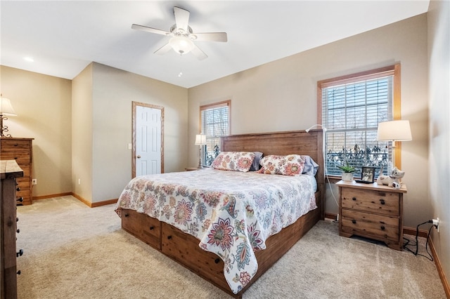 bedroom with ceiling fan and light colored carpet