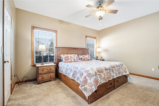 carpeted bedroom with ceiling fan and a closet