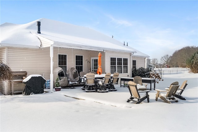 snow covered patio featuring grilling area