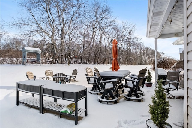 snow covered patio featuring a gazebo