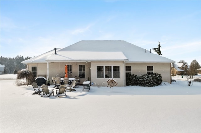 view of snow covered rear of property