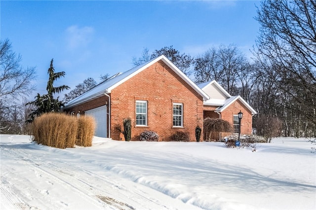 view of snowy exterior with a garage