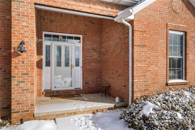 view of snow covered property entrance