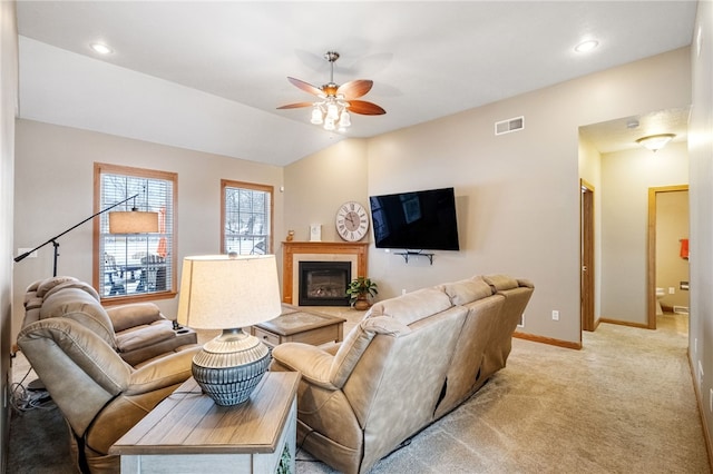 carpeted living room featuring ceiling fan and lofted ceiling