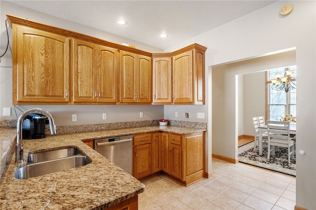 kitchen with stainless steel dishwasher, sink, light tile patterned floors, light stone counters, and a chandelier