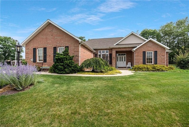 single story home featuring a front lawn