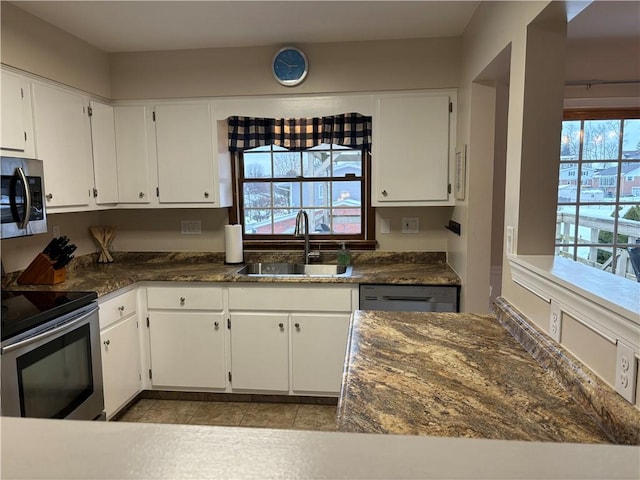 kitchen featuring black dishwasher, white cabinets, electric range, and sink