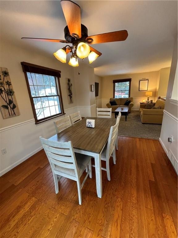 dining room featuring ceiling fan, wood-type flooring, and plenty of natural light