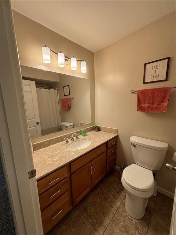 bathroom featuring toilet and vanity