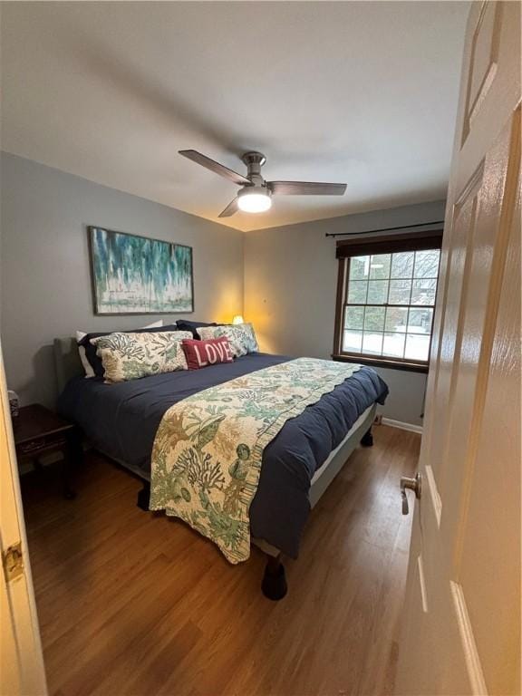 bedroom with ceiling fan and hardwood / wood-style floors