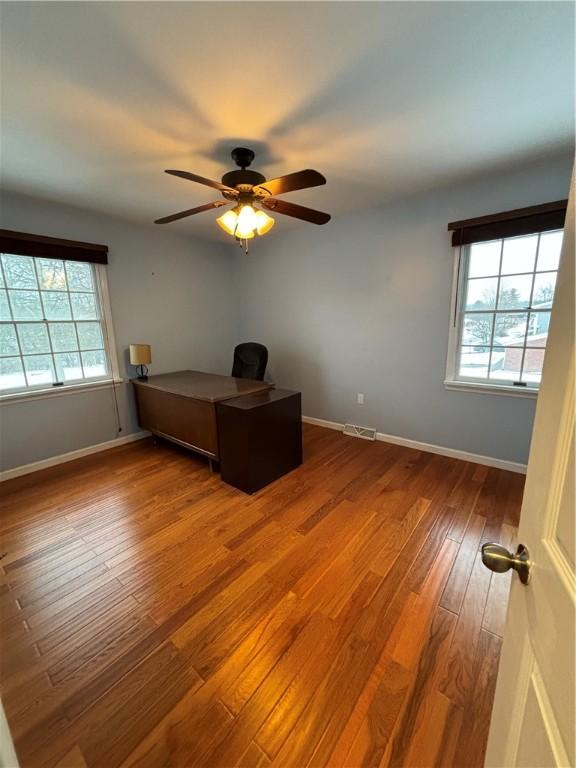 unfurnished bedroom with ceiling fan and hardwood / wood-style flooring