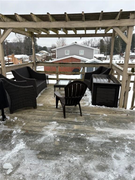 snow covered patio featuring a pergola