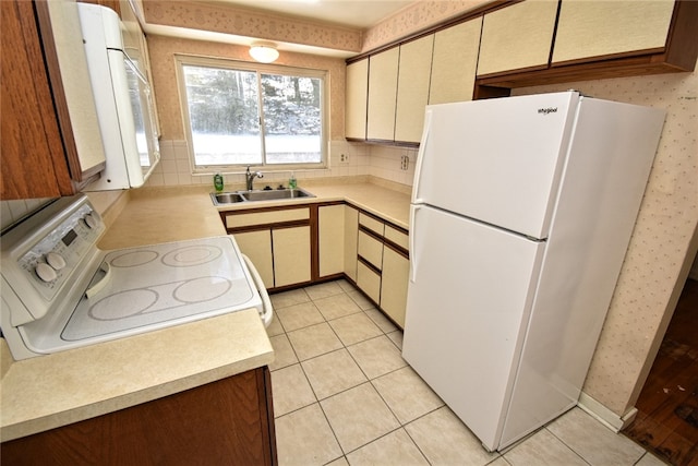 kitchen featuring light tile patterned floors, sink, decorative backsplash, and white appliances