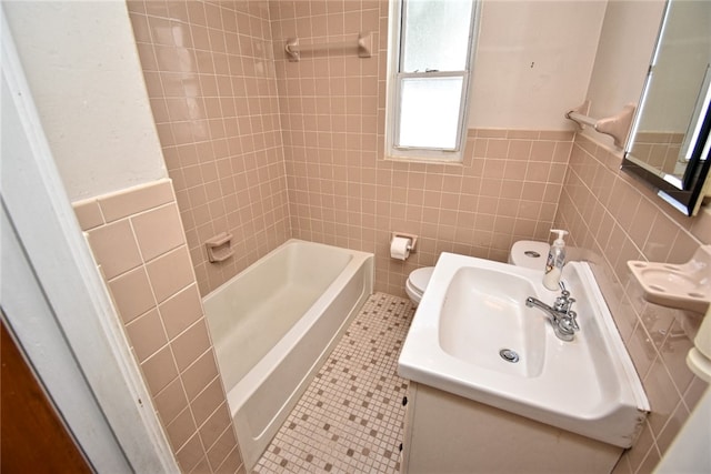 full bathroom featuring toilet, tile walls, tile patterned floors, and washtub / shower combination