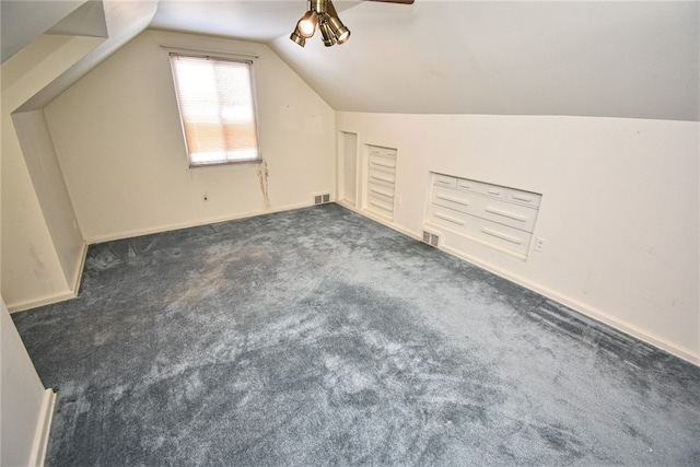 bonus room featuring ceiling fan, dark carpet, and vaulted ceiling