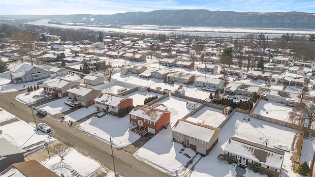 snowy aerial view with a mountain view