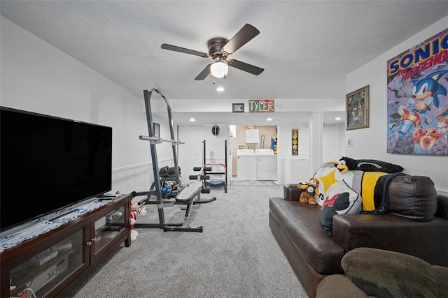 exercise area featuring carpet, washing machine and dryer, a textured ceiling, and ceiling fan